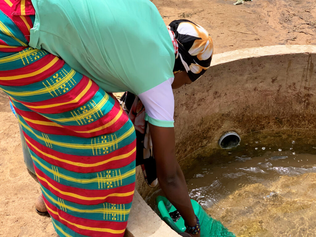Aissata draws water from a well