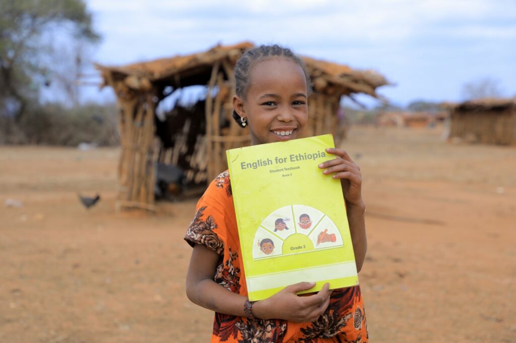 Jilo, 10, with her English for Ethiopia textbook