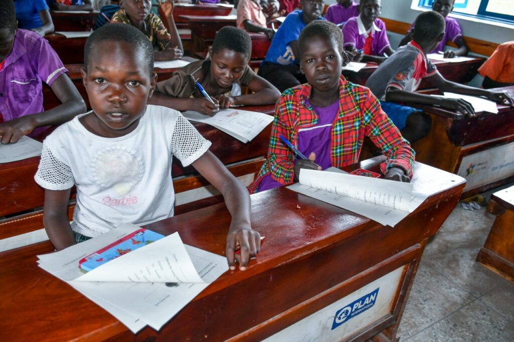 Girls complete tests at an accelerated learning school in Uganda