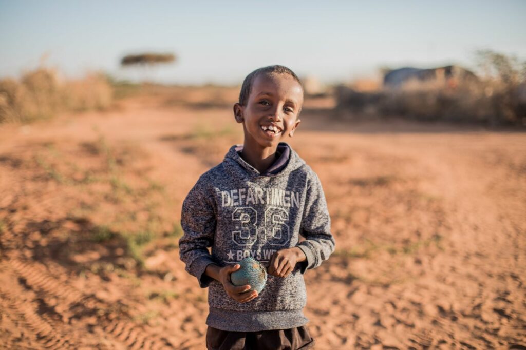 8 year-old Mubaarik holds his soft ball