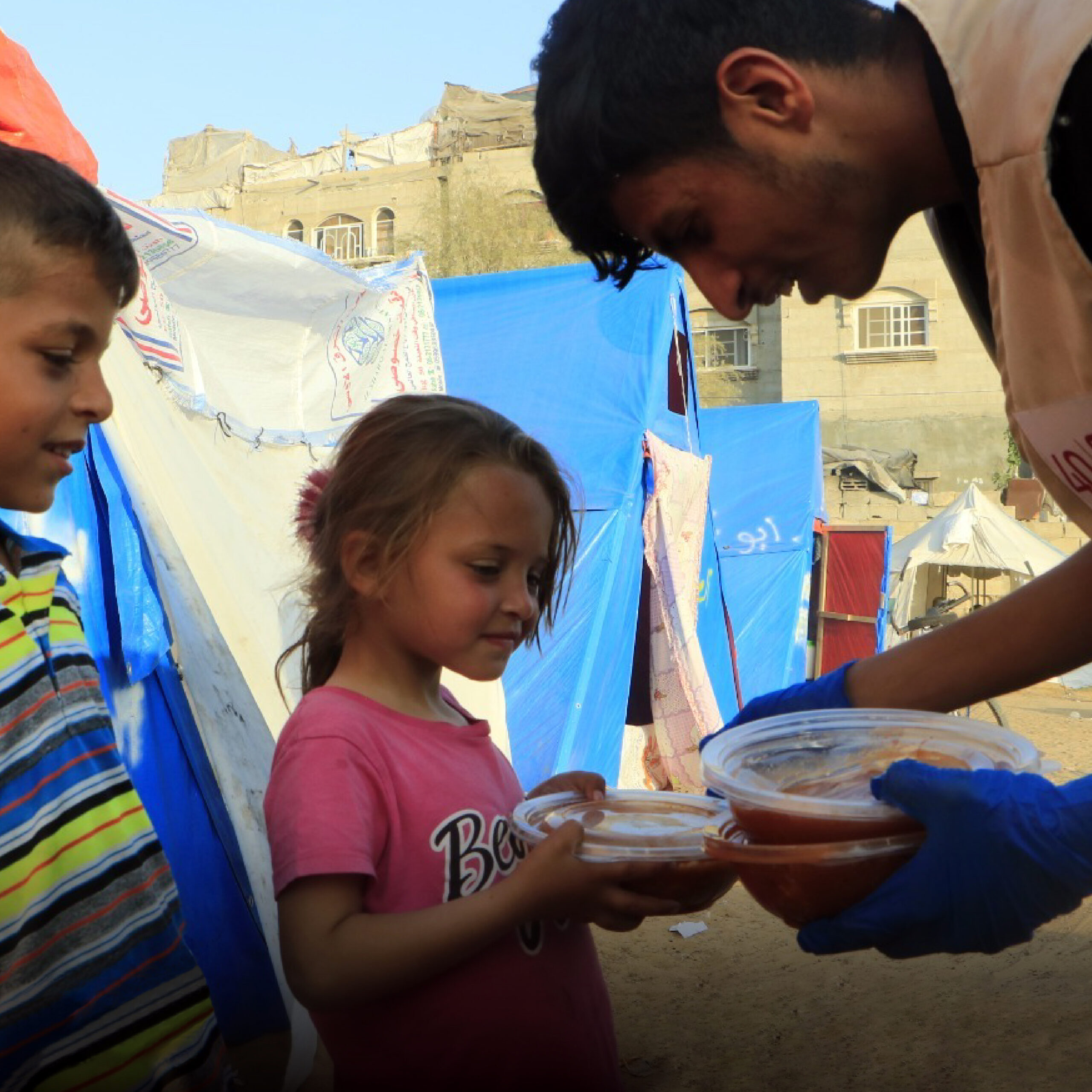 A worker provides a meal to a child.